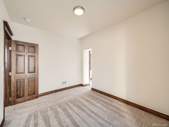 unfurnished bedroom with carpet flooring, visible vents, and baseboards