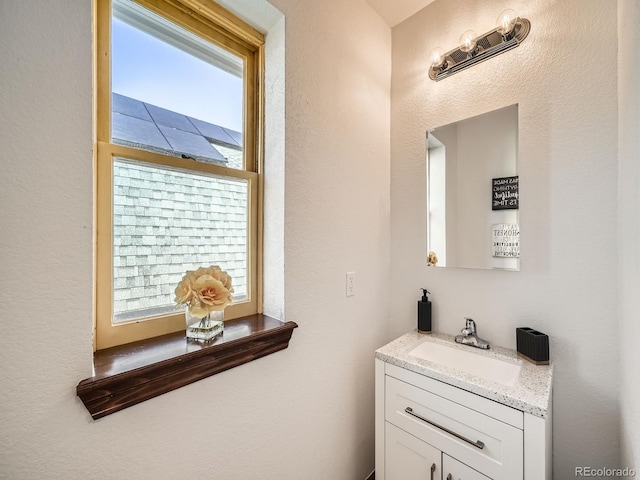 bathroom featuring plenty of natural light and vanity