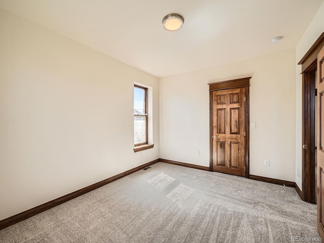 unfurnished bedroom with light carpet, visible vents, and baseboards