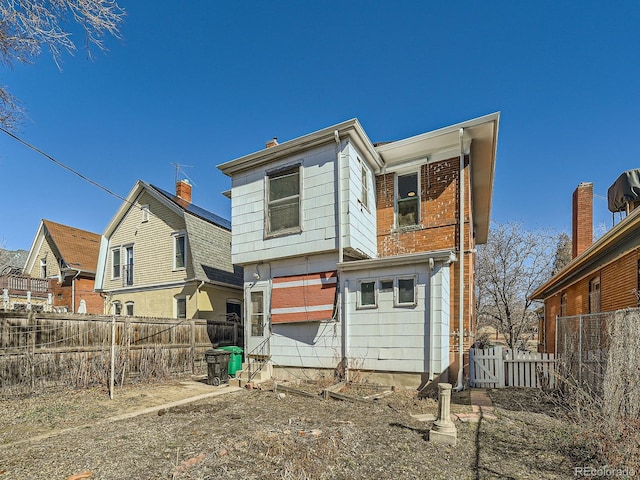 rear view of property with fence