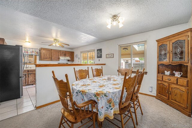 12244 Clermont Ct, Thornton, CO 80241 - dining area with light carpet, a textured ceiling, and a ceiling fan