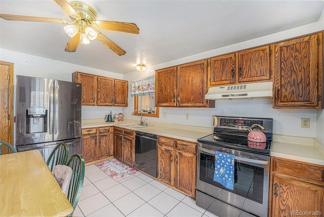 12244 Clermont Ct, Thornton, CO 80241 - kitchen featuring stainless steel appliances, under cabinet range hood, light tile patterned floors, and light countertops