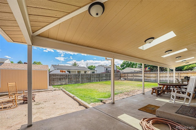 12244 Clermont Ct, Thornton, CO 80241 - fenced backyard with a patio area, outdoor dining area, and a shed