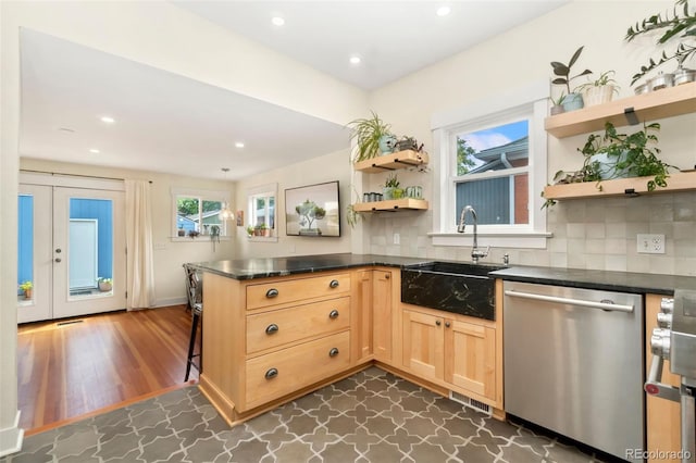 kitchen featuring decorative backsplash, kitchen peninsula, dishwasher, and dark wood-type flooring