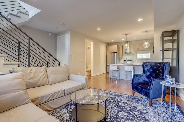 living room featuring light hardwood / wood-style flooring and sink