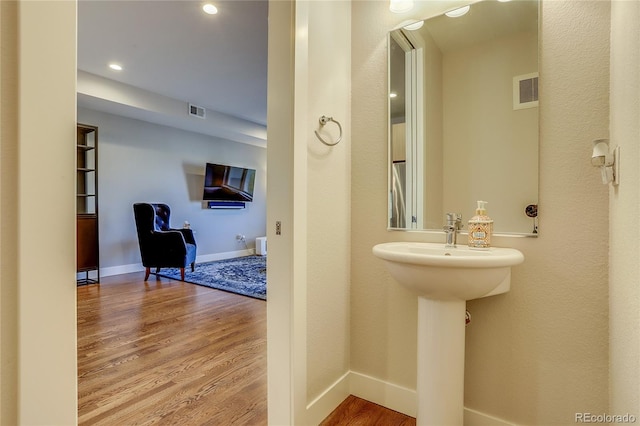 bathroom with hardwood / wood-style floors