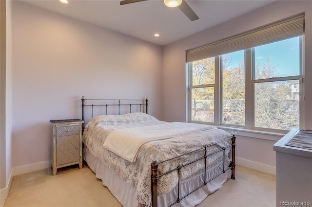 carpeted bedroom with multiple windows and ceiling fan