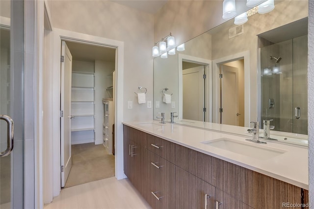 bathroom with vanity and a shower with shower door