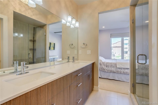 bathroom featuring vanity, tile patterned flooring, and an enclosed shower