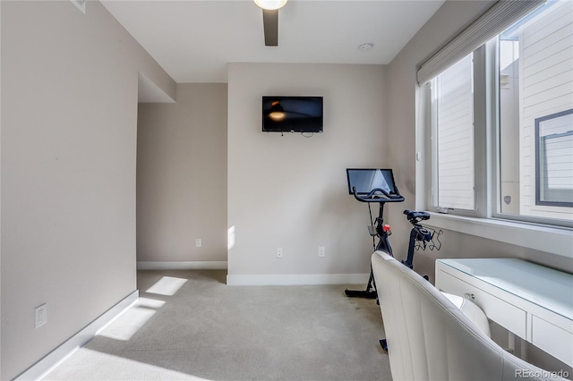 workout area with light colored carpet and ceiling fan