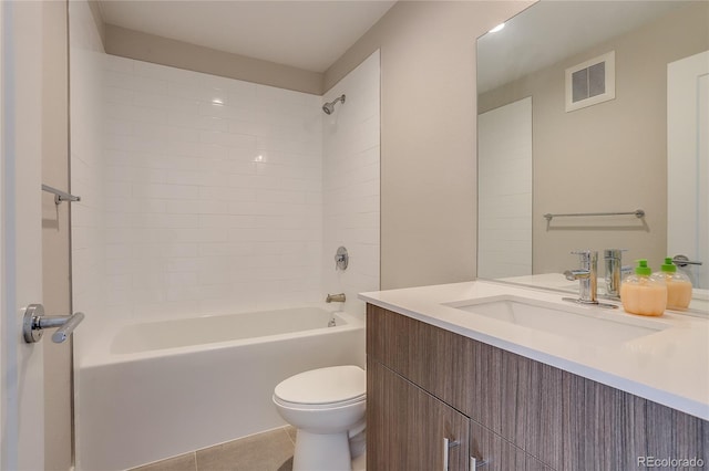 full bathroom featuring vanity, tiled shower / bath combo, toilet, and tile patterned floors