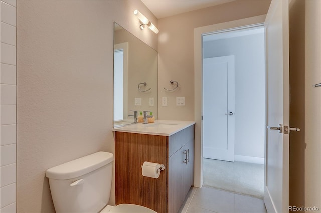 bathroom featuring vanity, toilet, and tile patterned floors