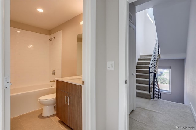 full bathroom featuring toilet, tiled shower / bath combo, vanity, and tile patterned floors