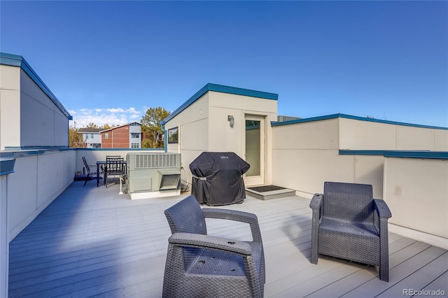 view of patio / terrace featuring a wooden deck and a grill