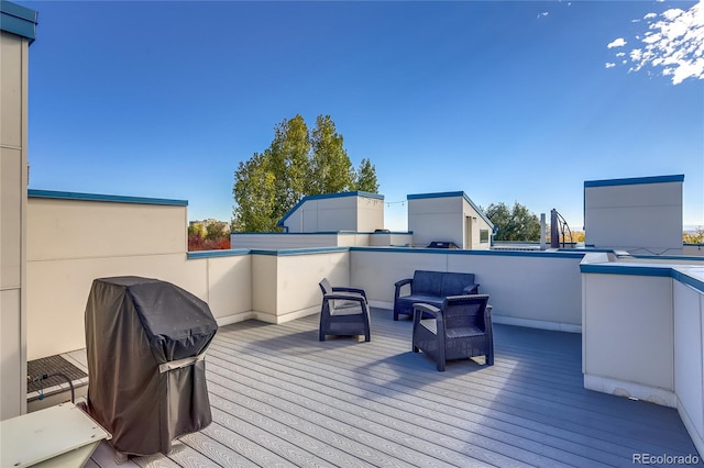 wooden terrace with a grill