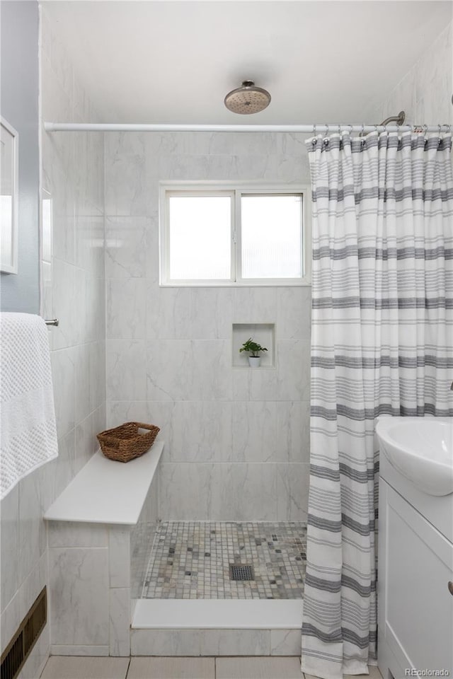 8240 Grandview Ave, Arvada, CO 80002 - bathroom featuring a tile shower and vanity