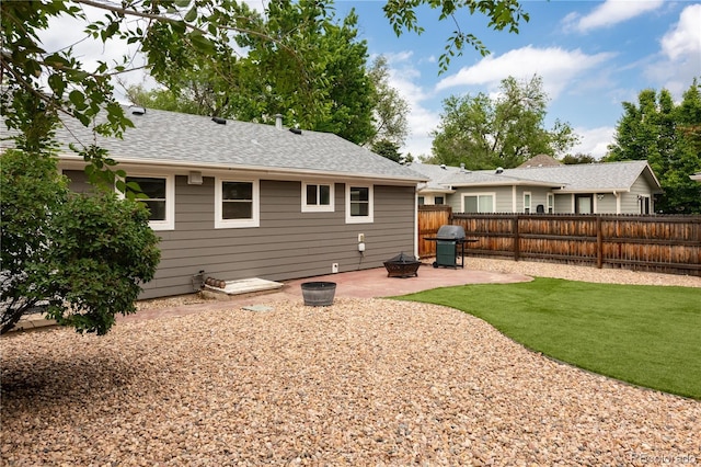 8240 Grandview Ave, Arvada, CO 80002 - rear view of property featuring a patio, roof with shingles, and a fire pit