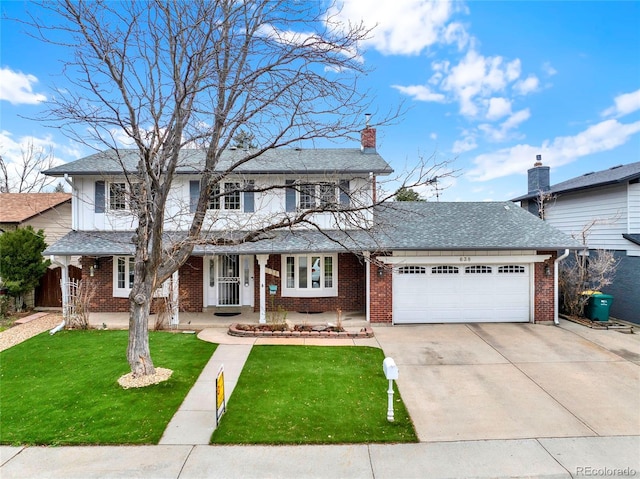traditional-style house featuring a front yard, concrete driveway, brick siding, a shingled roof, and a garage