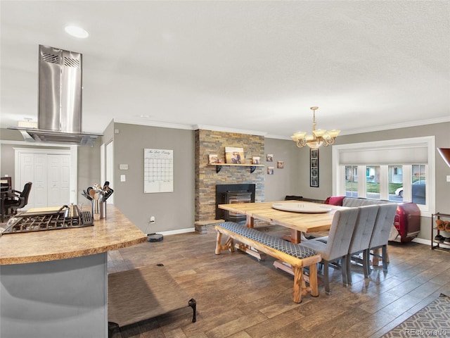 dining area with dark wood-type flooring, a fireplace, and crown molding