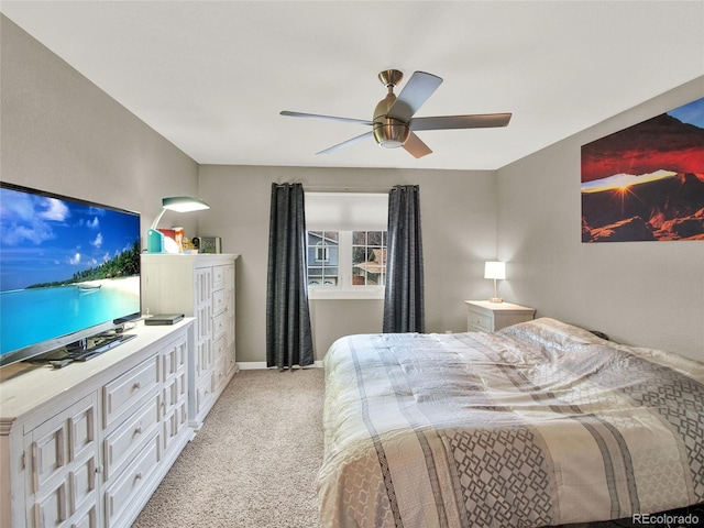 bedroom with baseboards, a ceiling fan, and light carpet