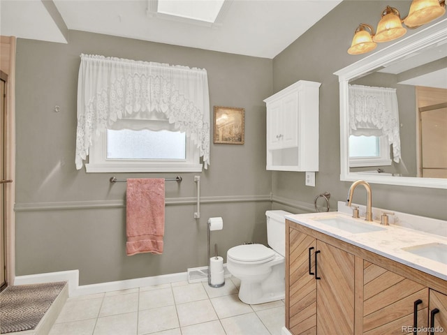bathroom featuring baseboards, a shower with shower door, toilet, tile patterned floors, and a sink