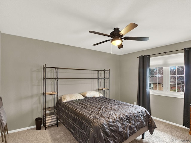 bedroom featuring baseboards, carpet flooring, and a ceiling fan