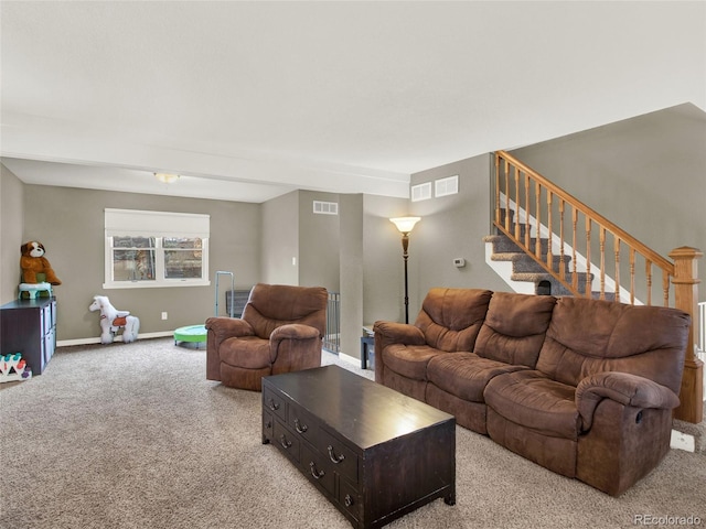living room with baseboards, visible vents, stairway, and light colored carpet