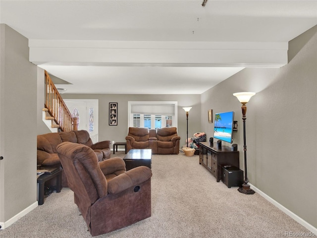 living room featuring baseboards, beamed ceiling, stairway, and carpet