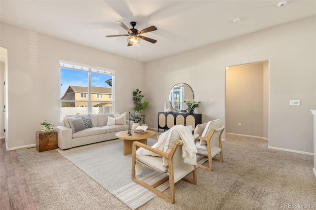 carpeted living room with ceiling fan