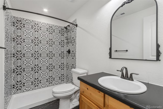 bathroom featuring vanity, toilet, and walk in shower