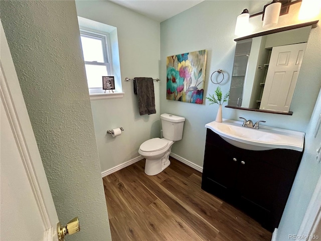 bathroom featuring hardwood / wood-style flooring, vanity, and toilet