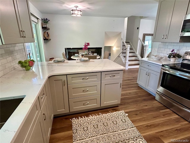 kitchen with gray cabinets, appliances with stainless steel finishes, and dark wood-type flooring