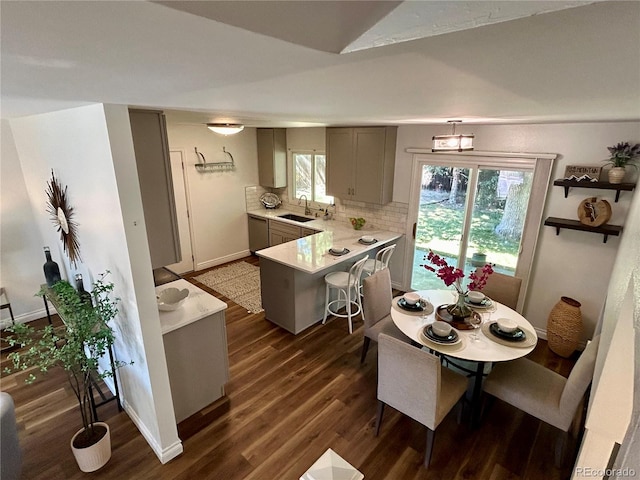 kitchen with gray cabinets, sink, tasteful backsplash, and a wealth of natural light