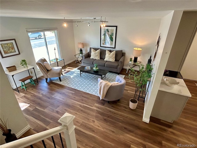 living room featuring lofted ceiling and dark hardwood / wood-style flooring