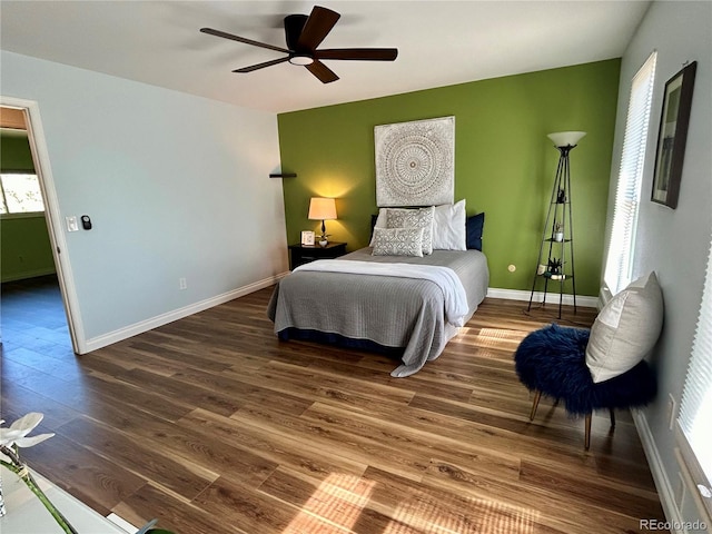 bedroom with ceiling fan and dark wood-type flooring