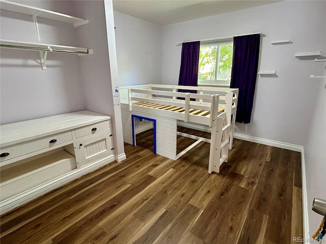 bedroom with a closet and dark wood-type flooring