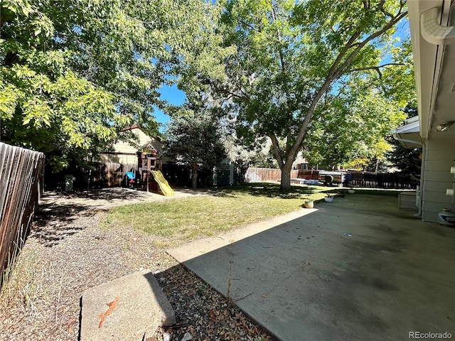 view of yard with a patio and a playground