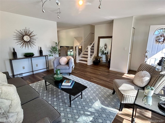 living room with wood-type flooring and track lighting