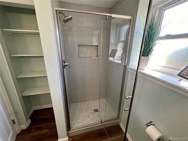 bathroom featuring hardwood / wood-style floors and an enclosed shower