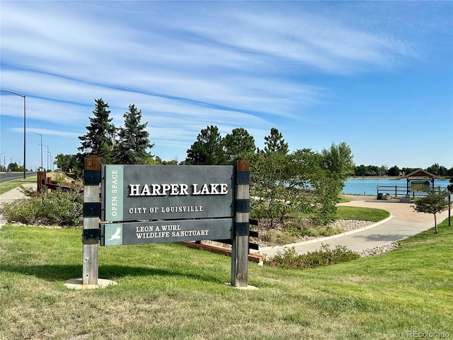 view of community featuring a lawn and a water view