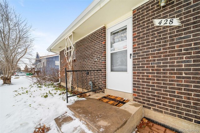 view of snow covered property entrance