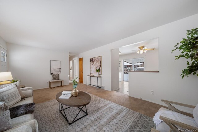 living room featuring carpet floors and ceiling fan