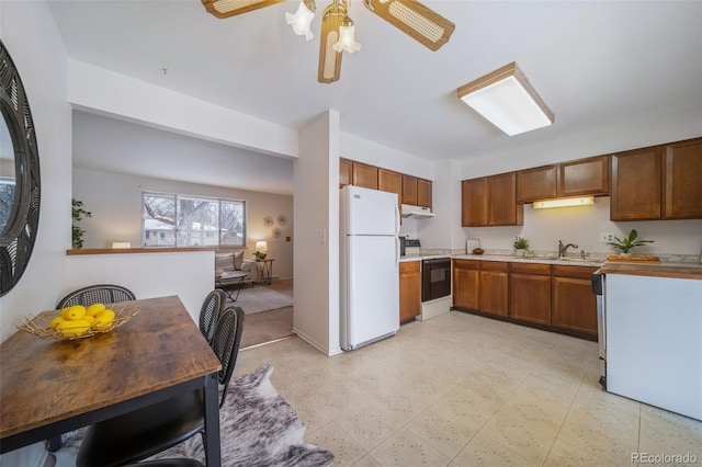 kitchen with pendant lighting, ceiling fan, white appliances, and sink