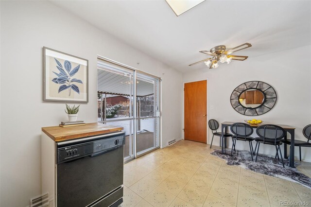 interior space featuring wood counters, black dishwasher, and ceiling fan