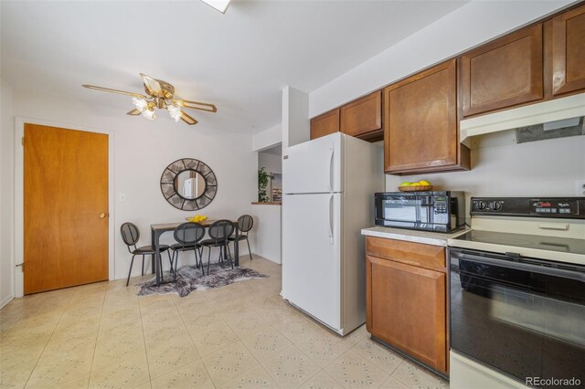 kitchen featuring white appliances and ceiling fan