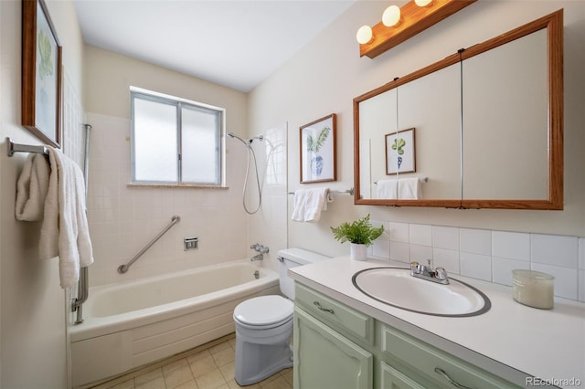 full bathroom featuring vanity, toilet, tiled shower / bath, and tasteful backsplash