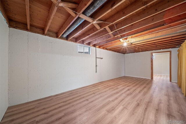 basement with light hardwood / wood-style flooring