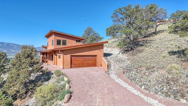 10405 W Cherokee Dr, Salida, CO 81201 - view of front of property with driveway, an attached garage, and stucco siding