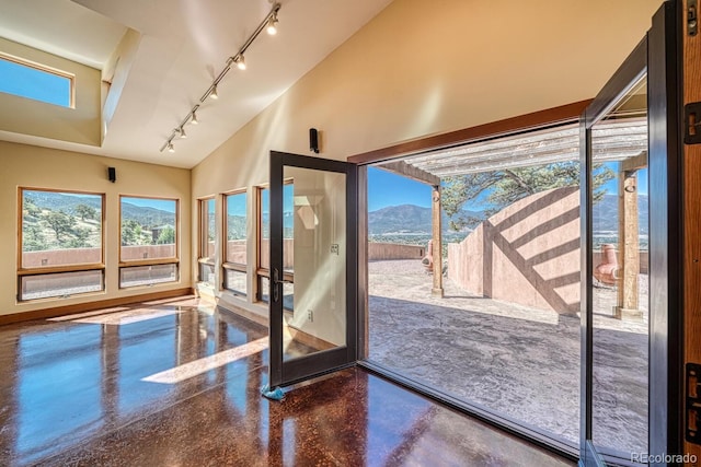 10405 W Cherokee Dr, Salida, CO 81201 - entryway featuring track lighting, a mountain view, high vaulted ceiling, and concrete floors