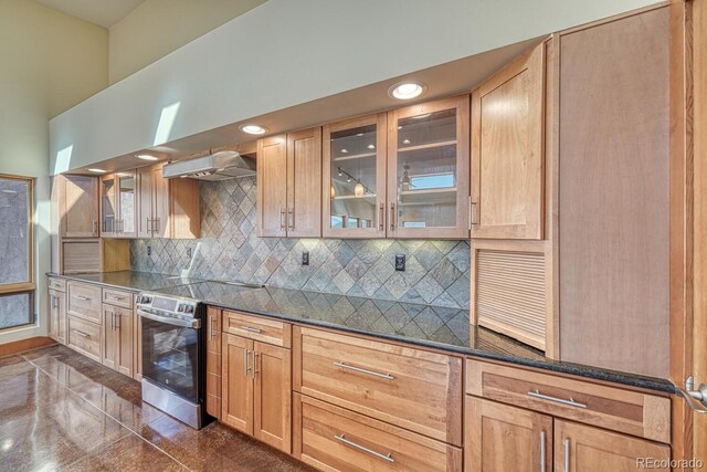 10405 W Cherokee Dr, Salida, CO 81201 - kitchen with electric stove, extractor fan, dark countertops, glass insert cabinets, and recessed lighting